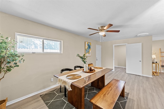 dining area featuring light wood-type flooring and ceiling fan