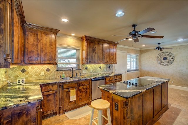 kitchen with tasteful backsplash, dark stone countertops, dishwasher, sink, and a center island