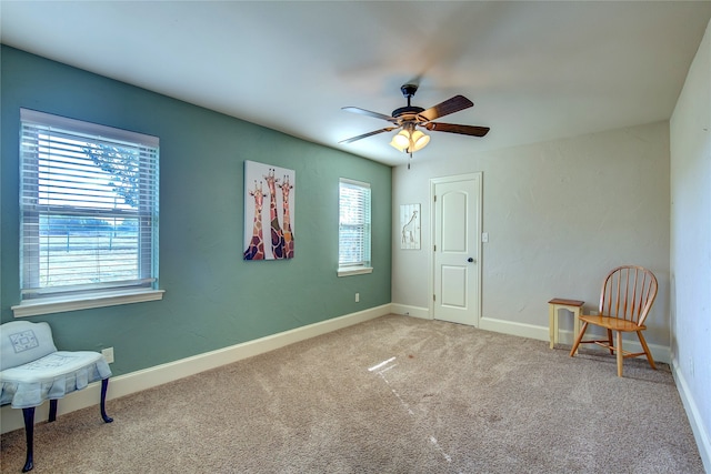 living area with ceiling fan and carpet floors