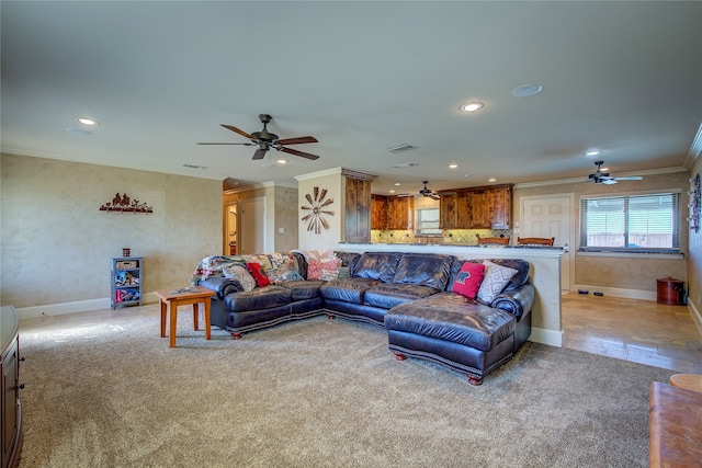 carpeted living room with crown molding and ceiling fan