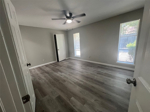 unfurnished room featuring ceiling fan and dark hardwood / wood-style floors