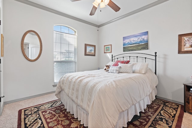 carpeted bedroom featuring crown molding and ceiling fan