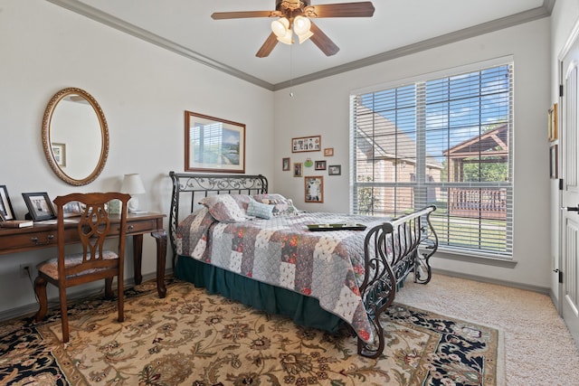 carpeted bedroom featuring ceiling fan and crown molding