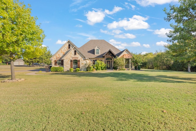 view of front of home with a front yard and a garage