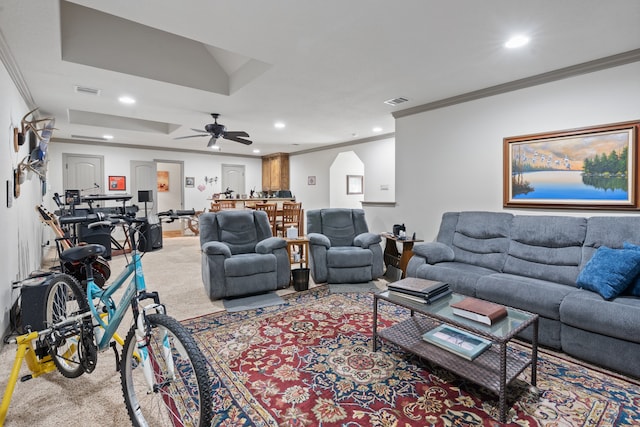 living room featuring crown molding, carpet floors, and ceiling fan