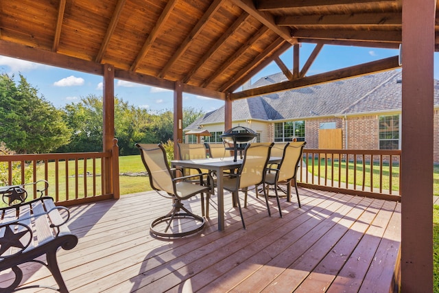 wooden deck featuring a yard