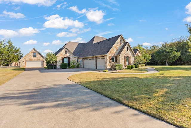 view of front of house featuring a front yard and a garage