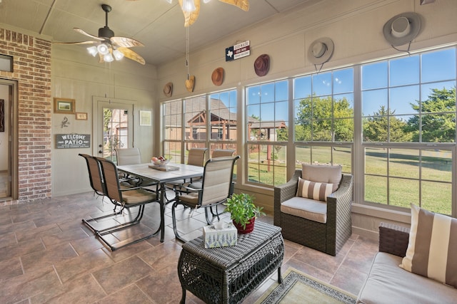 sunroom featuring ceiling fan