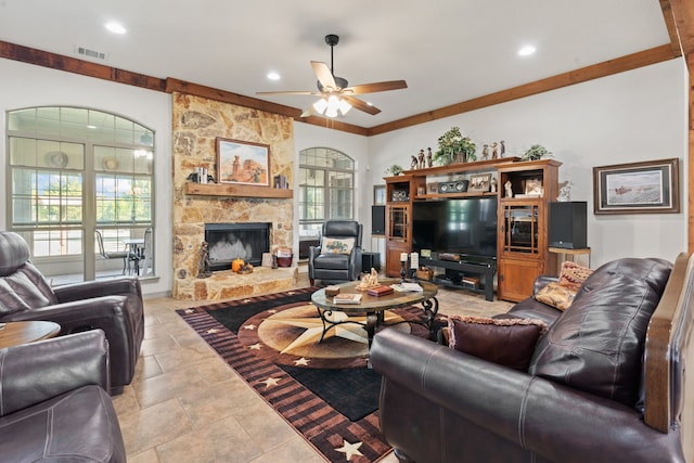 living room with ornamental molding, a fireplace, a healthy amount of sunlight, and ceiling fan