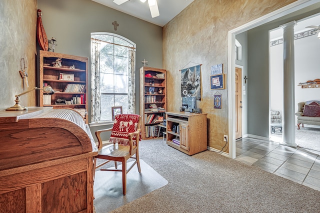 office space with ceiling fan, light colored carpet, and decorative columns