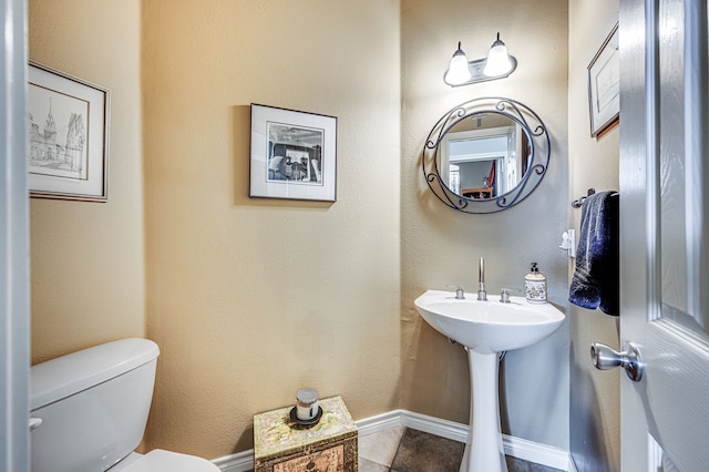 bathroom with tile patterned flooring and toilet