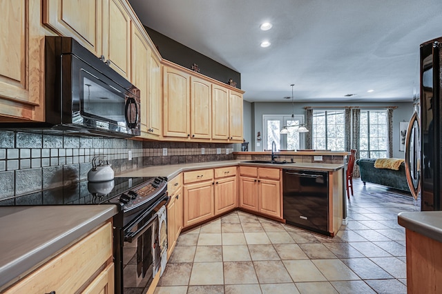 kitchen with sink, decorative light fixtures, black appliances, kitchen peninsula, and backsplash