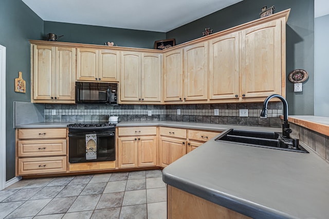 kitchen featuring light brown cabinetry, sink, tasteful backsplash, light tile patterned floors, and black appliances