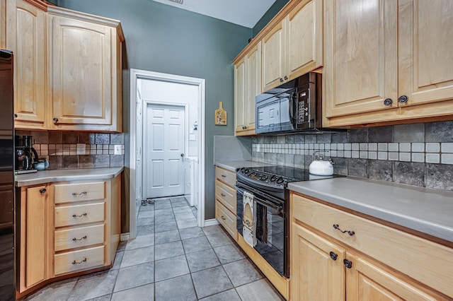 kitchen with tasteful backsplash, light tile patterned floors, light brown cabinets, and black appliances