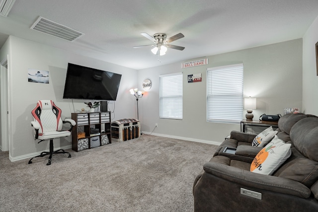 carpeted living room with ceiling fan