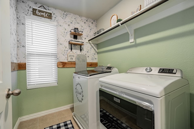 clothes washing area with tile patterned floors and washer and clothes dryer