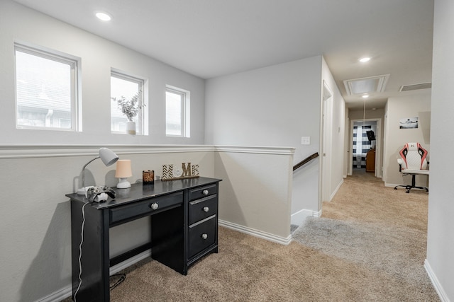 hall with light colored carpet