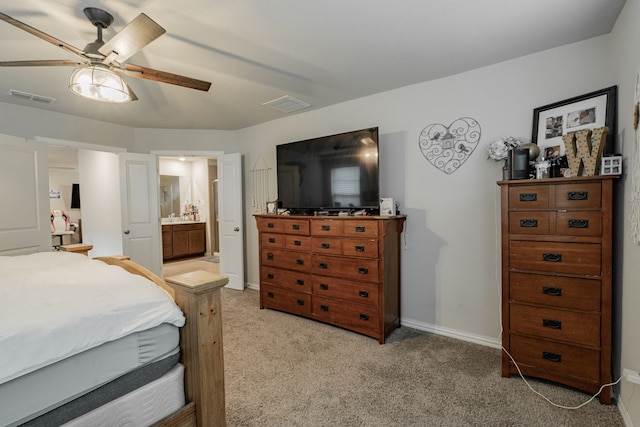 carpeted bedroom featuring ceiling fan and ensuite bath