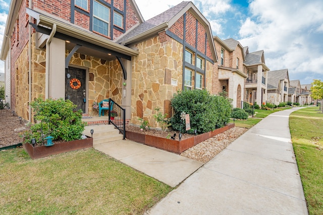 view of exterior entry featuring a yard