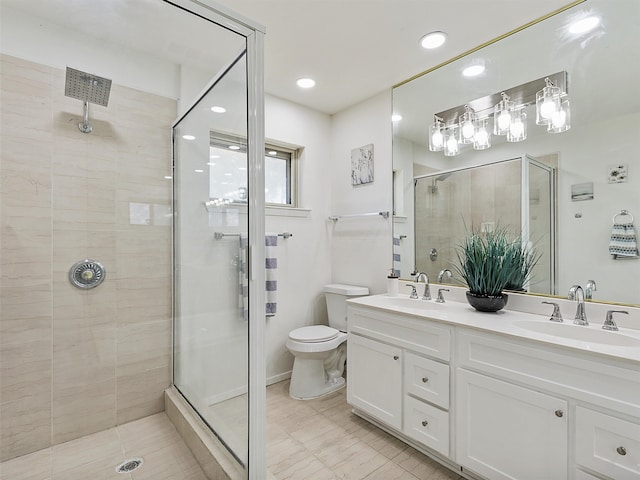 bathroom featuring toilet, walk in shower, and vanity