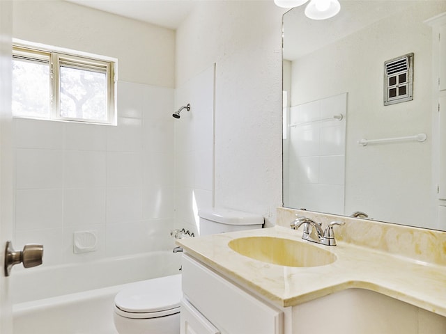 full bathroom with toilet, tiled shower / bath, and vanity