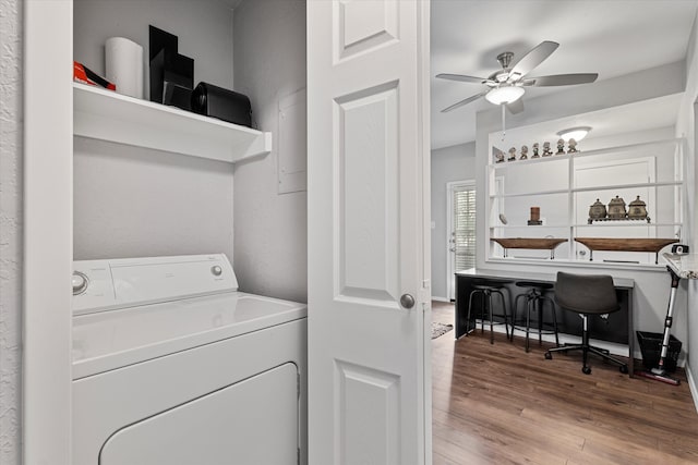 clothes washing area with washer / dryer, ceiling fan, and light hardwood / wood-style flooring