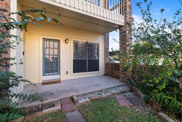 doorway to property featuring a patio and a balcony