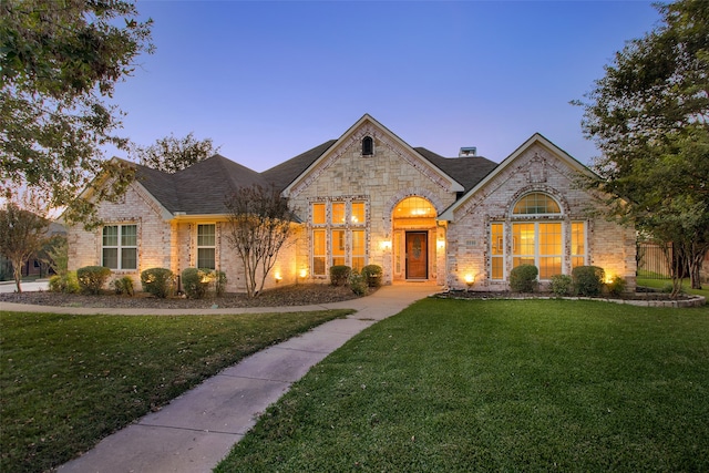 view of front of property with a lawn