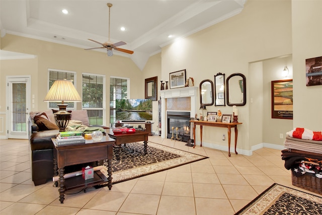 living room with crown molding, ceiling fan, and light tile patterned floors