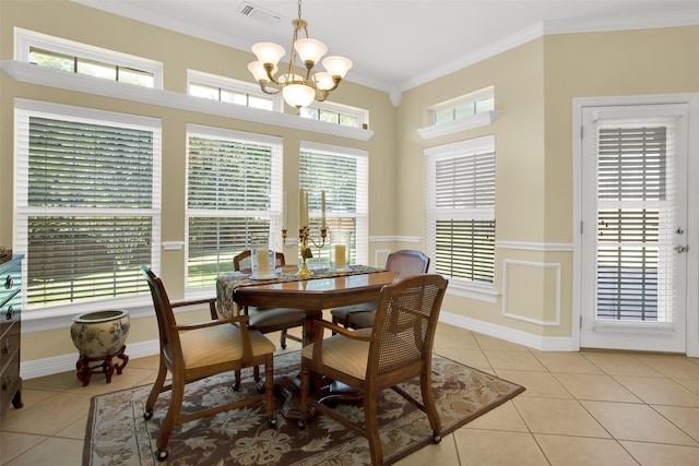 tiled dining area with a notable chandelier, ornamental molding, and a wealth of natural light