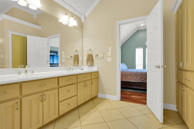 bathroom with vanity, crown molding, lofted ceiling, and tile patterned flooring