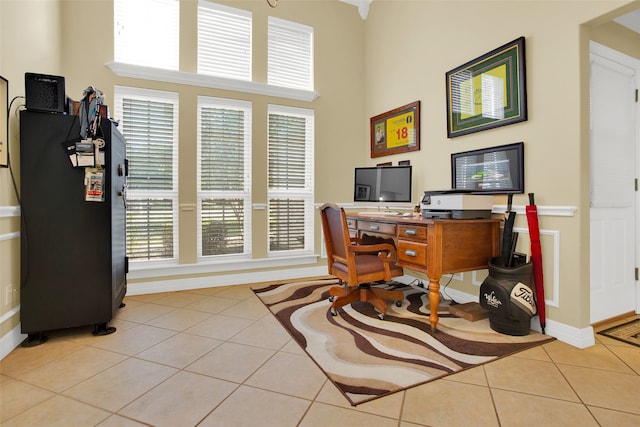 tiled home office featuring a high ceiling