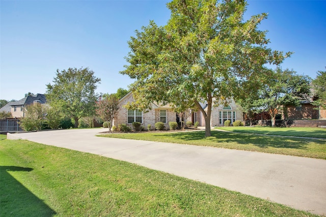 obstructed view of property featuring a front lawn