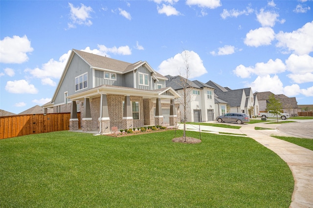 view of front of house featuring a front yard, a porch, and a garage