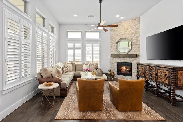 living room with a fireplace, dark hardwood / wood-style floors, and ceiling fan