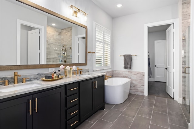 bathroom featuring vanity, tile walls, separate shower and tub, and tile patterned flooring