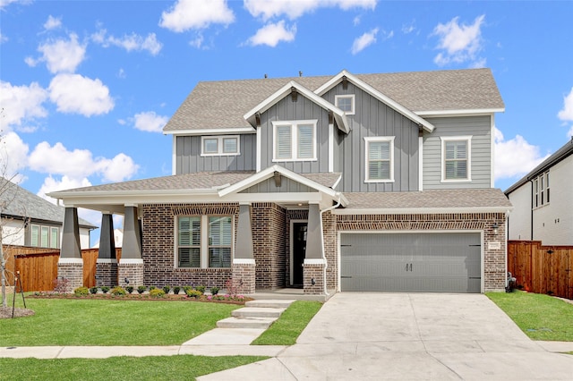 craftsman house with a front lawn and a garage