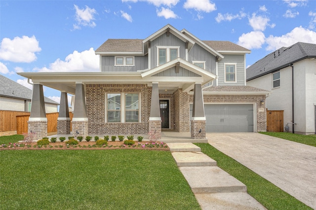 craftsman-style home featuring a front yard, a garage, and a porch