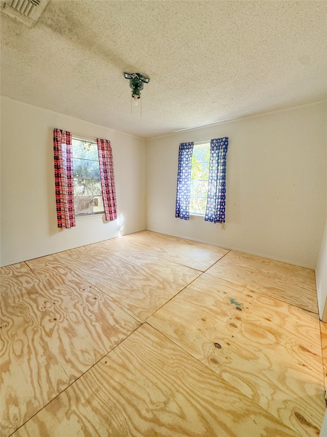 empty room featuring a textured ceiling