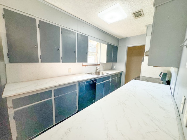 kitchen featuring sink, dishwasher, a textured ceiling, and range