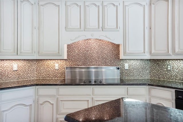 kitchen featuring white cabinets and decorative backsplash