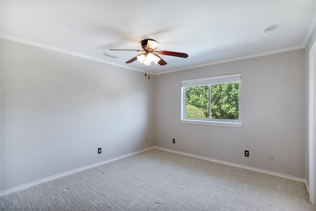 carpeted spare room featuring crown molding and ceiling fan