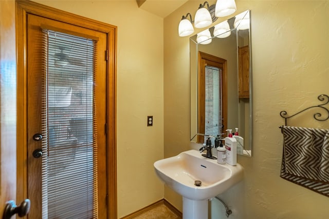 bathroom with sink and an inviting chandelier