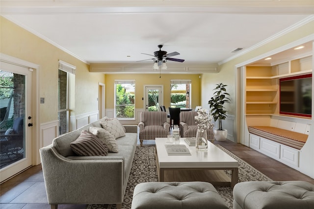 tiled living room featuring ceiling fan and crown molding