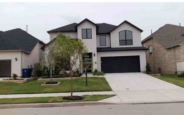 french provincial home with a front yard and a garage