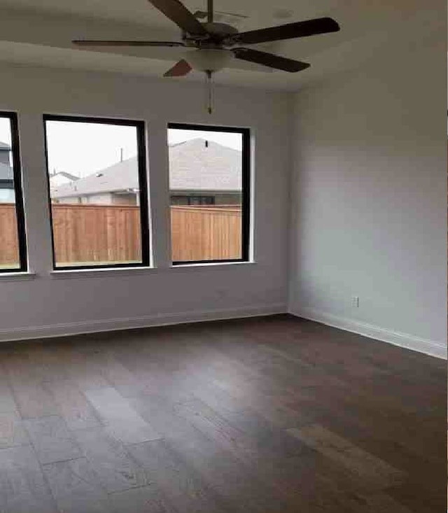 unfurnished room with ceiling fan and dark hardwood / wood-style floors