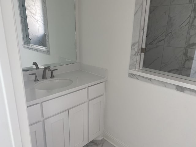 bathroom featuring vanity and a shower