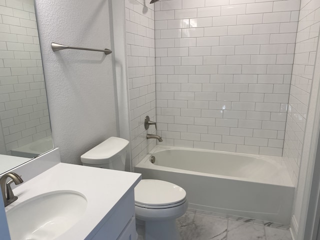 full bathroom with vanity, toilet, and tiled shower / bath