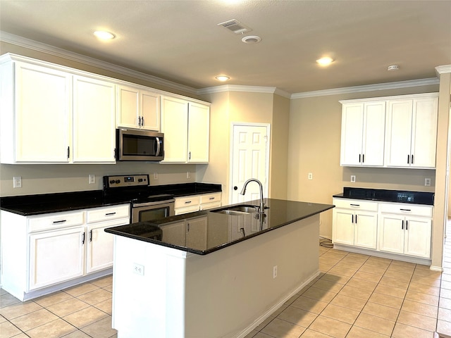 kitchen featuring an island with sink, white cabinetry, sink, and appliances with stainless steel finishes