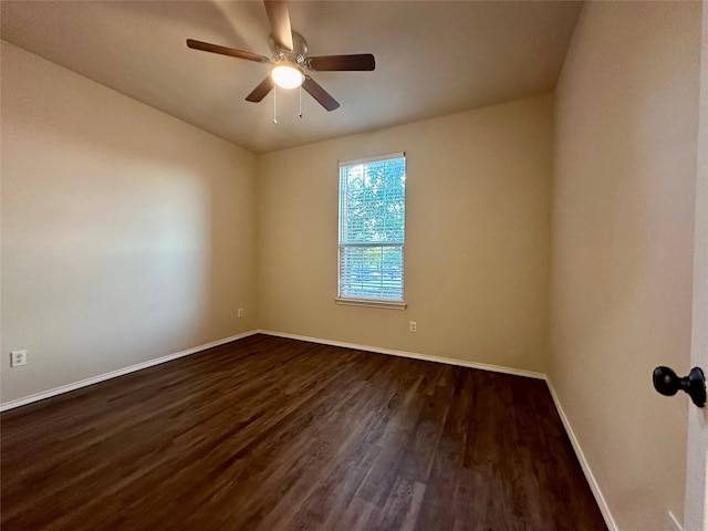 spare room with dark hardwood / wood-style floors and ceiling fan